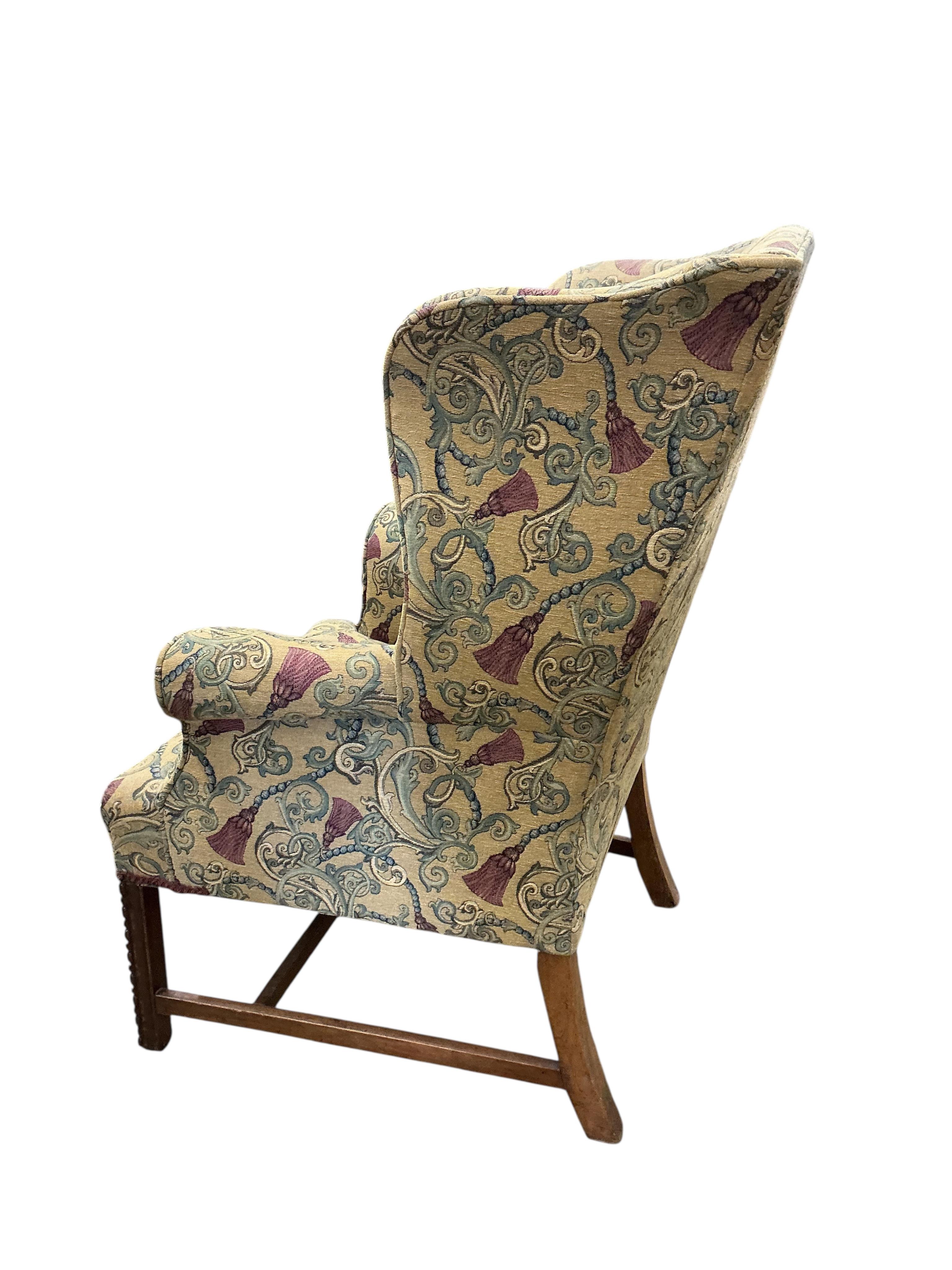 A George III style upholstered wing armchair, width 78cm, depth 66cm, height 103cm
